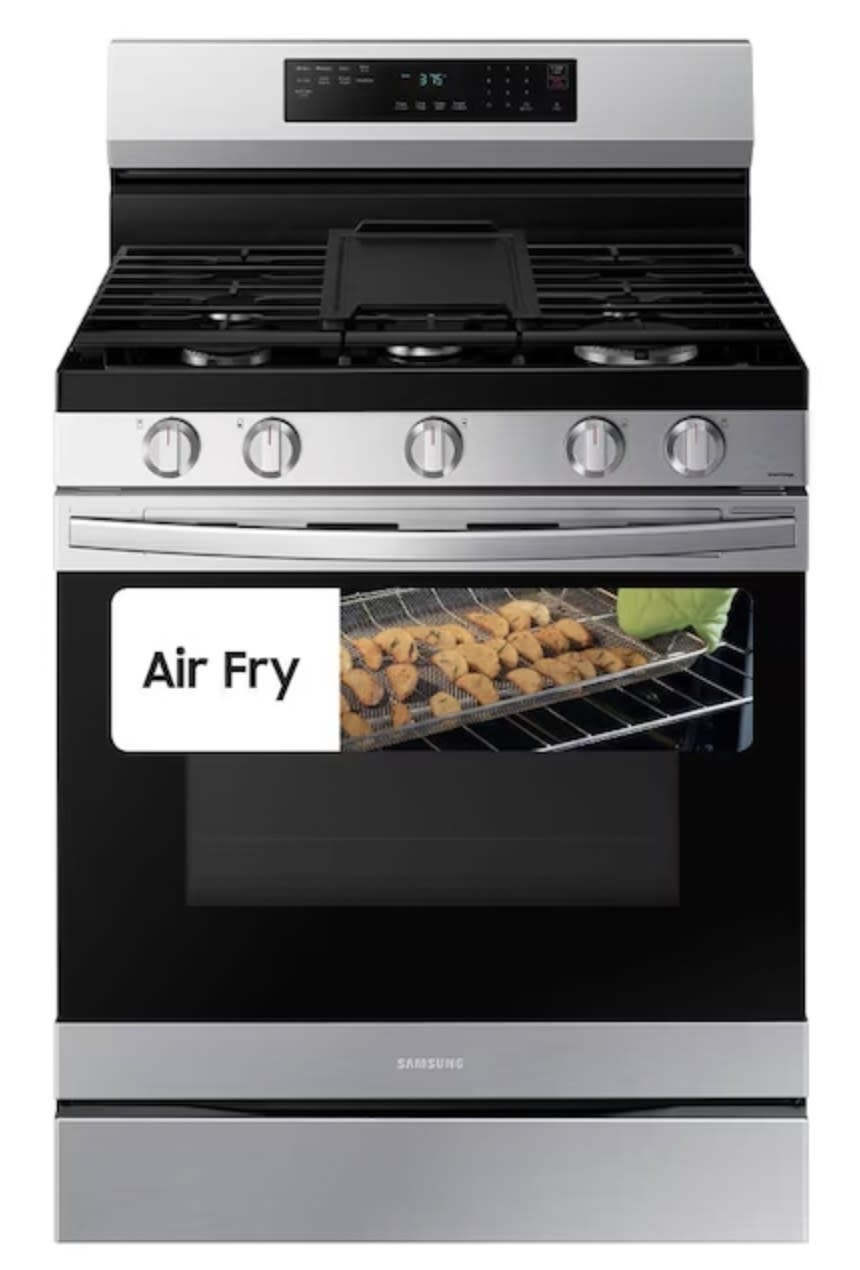 The oven showing fries inside being air fried