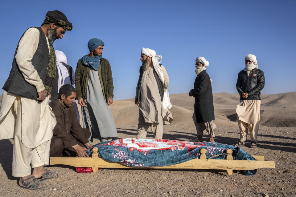 Afghan people mourn their relatives killed in an earthquake at a burial site in Zenda Jan district in Herat province, western of Afghanistan, Sunday, Oct. 8, 2023. Powerful earthquakes killed at least 2,000 people in western Afghanistan, a Taliban government spokesman said Sunday. It's one of the deadliest earthquakes to strike the country in two decades. (AP Photo/Ebrahim Noroozi)