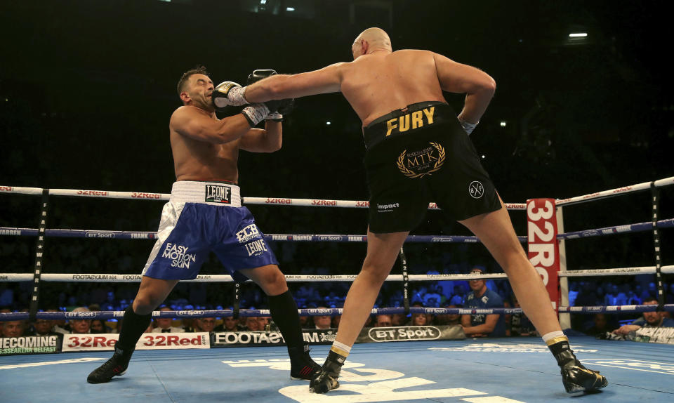 Britain’s Tyson Fury, right, punches Sefer Seferi during their heavyweight bout at the Manchester Arena, in Manchester, England, Saturday June 9, 2018. (AP)