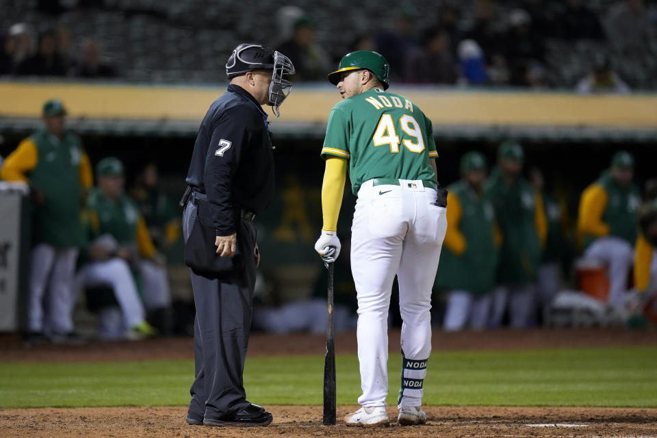 Oakland Athletics' Ryan Noda, right, talks with home plate umpire Brian O'Nora, left, after being called out on strikes against the Seattle Mariners during the eighth inning of a baseball game in Oakland, Calif., Tuesday, May 2, 2023. (AP Photo/Godofredo A. Vásquez)