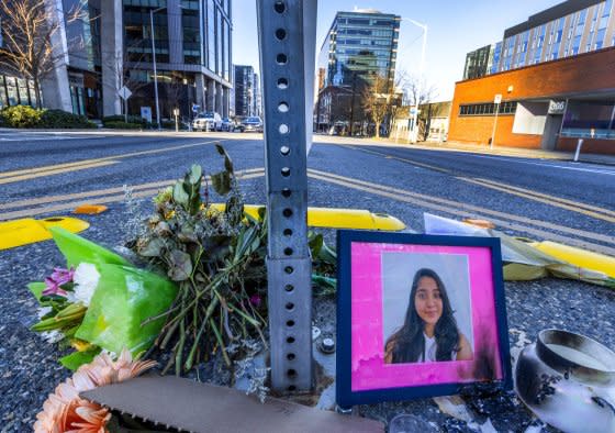 A photo of Jaahnavi Kandula is displayed with flowers on Jan. 29, 2023 in Seattle, at the intersection where she was killed by a Seattle Police officer.<span class="copyright">Ken Lambert—The Seattle Times/AP</span>