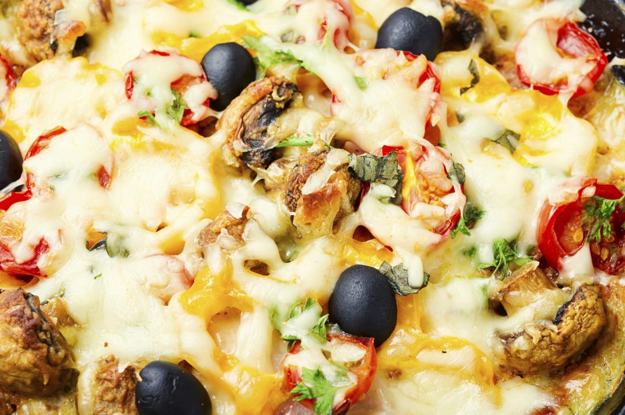 Appetizing Italian pizza with chicken breast, tomato,cheese and olives