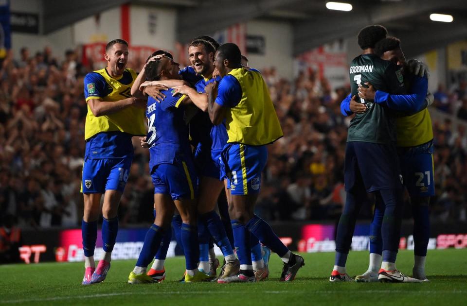 Night to remember: AFC Wimbledon ousted Ipswich on penalties to tee up a clash with Newcastle in round three (Getty Images)