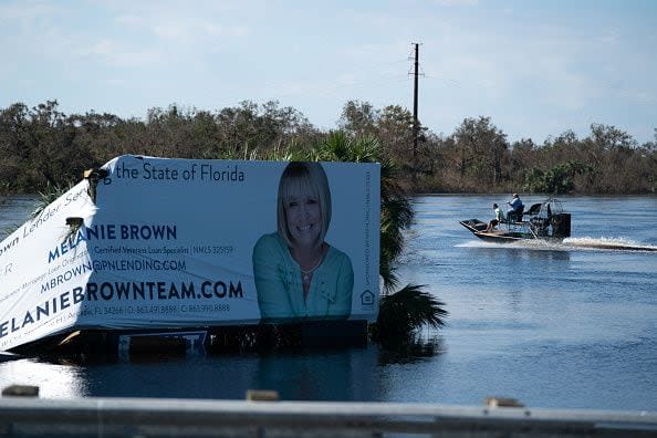 People ride on an airboat along Peace River in the wake of Hurricane Ian on October 4, 2022, in Arcadia, Florida. Fifty miles inland, and nearly a week after Hurricane Ian made landfall on the Gulf Coast of Florida, the record-breaking floodwaters in the area are receding to reveal the full effects of the storm.