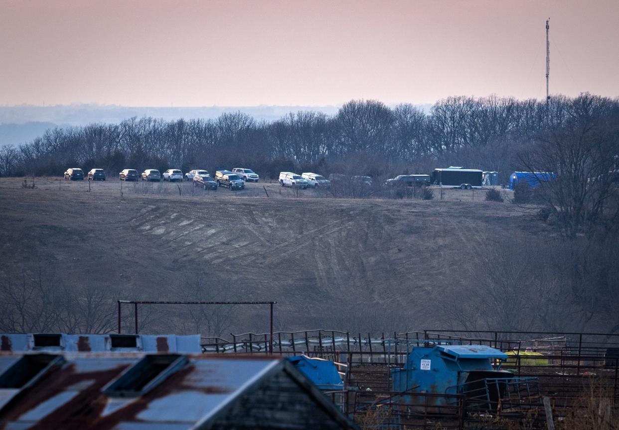 A line of vehicles is parked Wednesday near the southwest Iowa site where authorities searched for human remains said to have been buried there by a serial killer. The Iowa Division of Criminal Investigation said it had turned up no evidence.