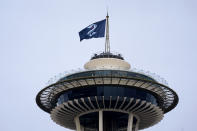 A Seattle Kraken hockey team flag flies atop the Space Needle on Saturday afternoon, Oct. 23, 2021, in Seattle, before the Kraken's inaugural home match as the newest NHL team, against the Vancouver Canucks later Saturday. (AP Photo/Elaine Thompson)