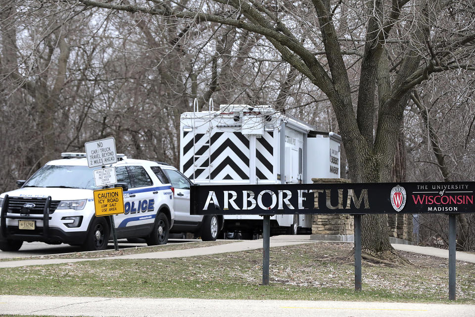 Vehicles from the Madison Police Department, Dane County Sheriff's Office and the University of Wisconsin Police Department are stationed outside the UW-Arboretum in Madison, Wis. as law enforcement personnel investigate a double homicide Tuesday, March 31, 2020. (John Hart/Wisconsin State Journal via AP)