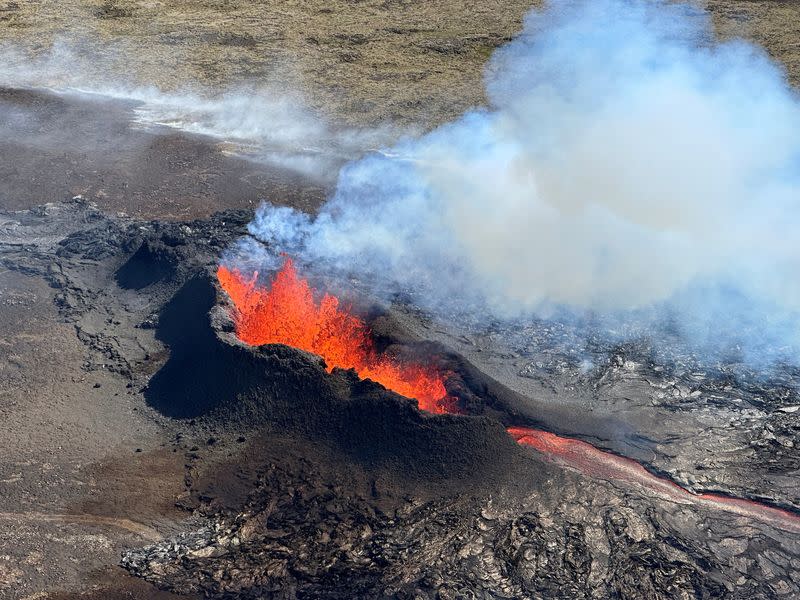FILE PHOTO: Lava spurts and flows after the eruption of a volcano in the Reykjanes Peninsula
