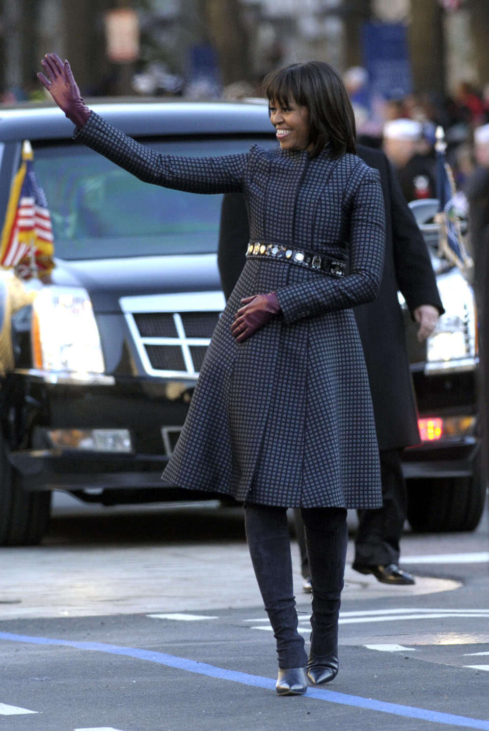 FILE - In this Jan. 21, 2013 file photo, first lady Michelle Obama waves as she walks in the Inaugural Parade wearing an outfit by fashion designer Thom Browne. Browne is building a business _ and what he hopes is a smart, long-lasting business at that. He's just not the overzealous, mercurial artiste. (AP Photo/Susan Walsh, File)