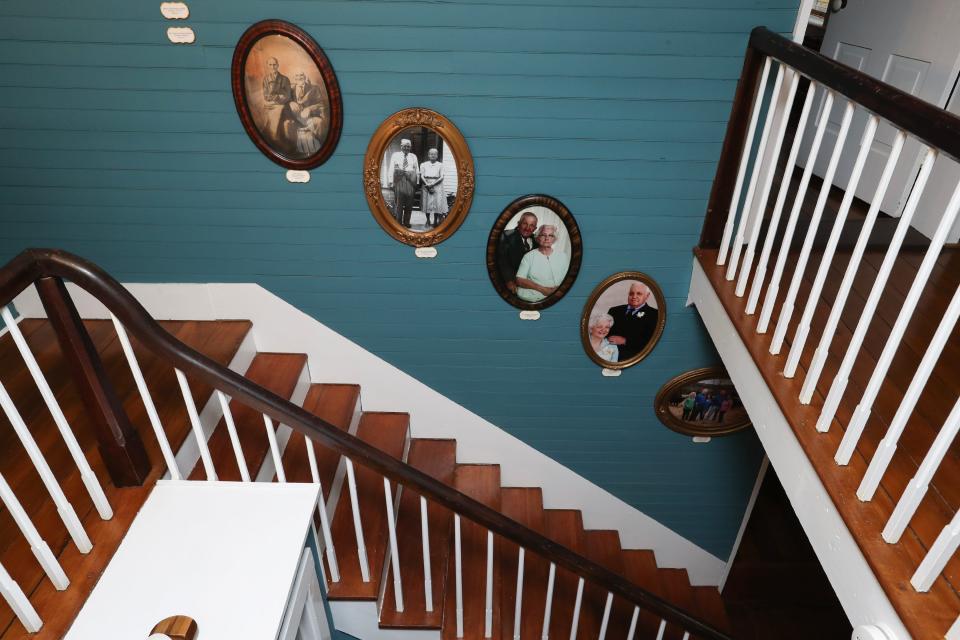 The main stairwell is decorated with portraits of multiple generations of the Hutchins family inside their family home built in 1780 in Bardstown, Ky. on Oct. 24, 2023.
