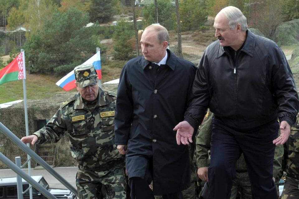 FILE - Russian President Vladimir Putin and Belarusian President Alexander Lukashenko, right, arrive to watch the West-2013 joint military games at the Gozhsky shooting range in Grodno, Belarus, Thursday, Sept. 26, 2013. Lukashenko this week once again accused Ukraine of planning to attack it and announced creating a joint grouping of troops with Moscow, a move that stocked fears that Belarusian army could join Russian forces in Ukrainian trenches. (Alexei Druzhinin, Sputnik, Kremlin Pool Photo via AP, File)