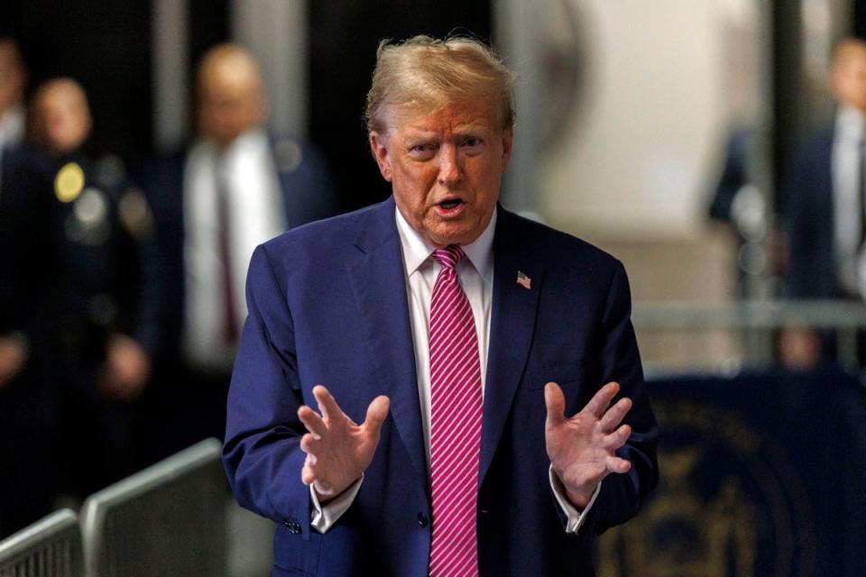 Former president Donald Trump speaks with the media at his trial on Friday 19 April (AP)