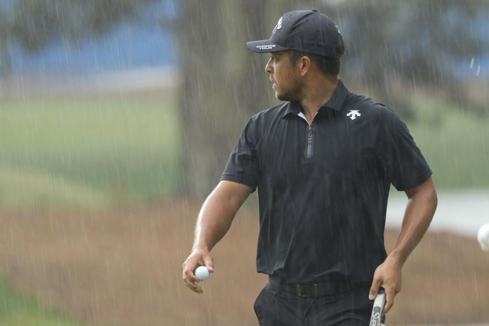 Xander Schauffele waits to play in the rain on the 15th hole during the final round of the RBC Heritage golf tournament, Sunday, April 21, 2024, in Hilton Head Island, S.C. (AP Photo/Chris Carlson)
