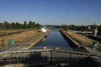 General view of the lock of Notre Dame de la Garenne where a Beluga whale is being prepared to be moved, in Saint-Pierre-la-Garenne, west of Paris, France, Tuesday, Aug. 9, 2022. French environmentalists are moving a dangerously think Beluga that had strayed into the Seine River last week to a salt-water river basin to try and save its life. Lamya Essemlali, president of Sea Shepherd France, said the ethereal white mammal measuring 4-meters will be transported to the salty water for "a period of care" by medics who suspect the mammal is sick. (AP Photo/Aurelien Morissard)