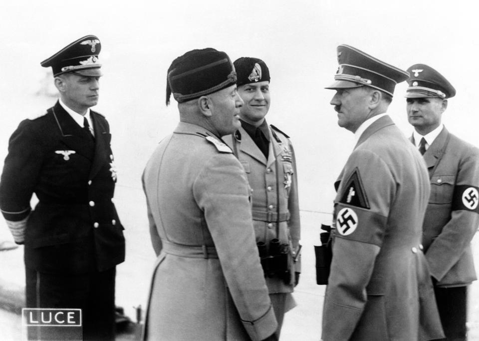 German Chancellor Adolf Hitler (2nd from right), German Foreign Minister Joachim von Ribbentrop (left), Italian dictator Benito Mussolini (2nd from left) and his Minister for Foreign Affairs, Count Ciano, attended the big naval manoeuvres held in honour of Hitler in Naples Bay, under the shadow of Vesuvius, Italy on May 5, 1938. / Credit: AP