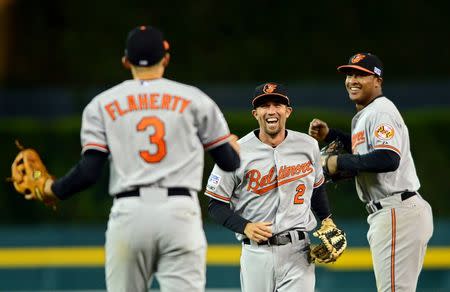 Oct 5, 2014; Detroit, MI, USA; Baltimore Orioles shortstop J.J. Hardy (2), third baseman Ryan Flaherty (3) and second baseman Jonathan Schoop (6) celebrate after defeating the Detroit Tigers in game three of the 2014 ALDS baseball playoff game at Comerica Park. The Orioles move on to the ALCS with 2-1 win over the Tigers. Mandatory Credit: Andrew Weber-USA TODAY Sports