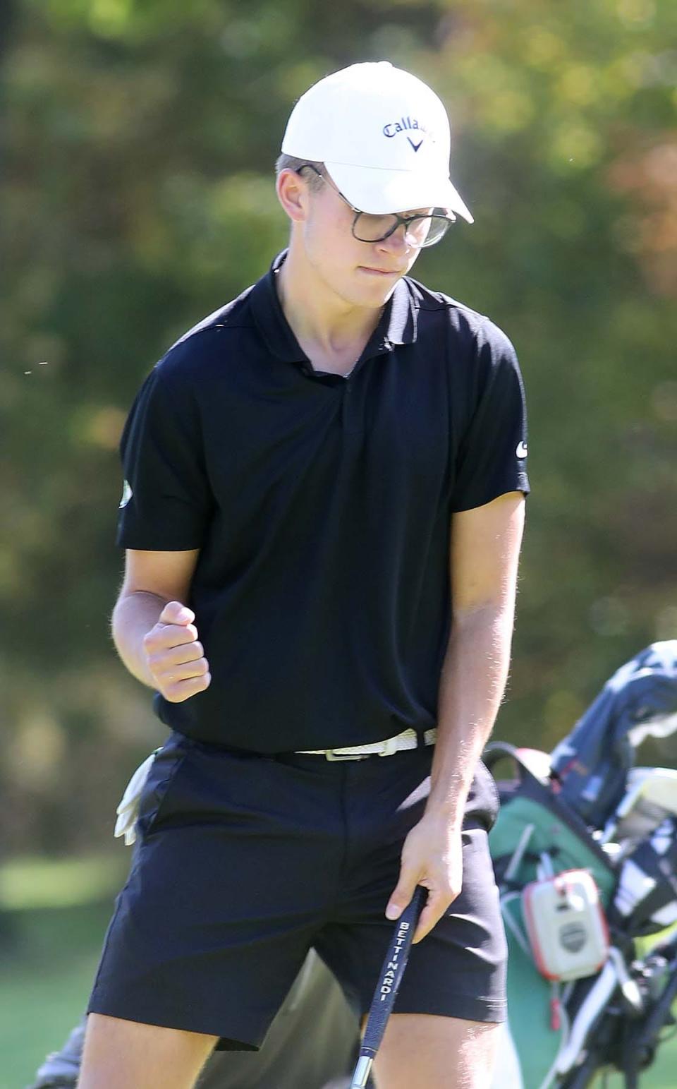 Preston Trumpler of Medina reacts to sinking a putt during the Division I Boys District Golf Tournament at Pine Hills Golf Course in Hinckley on Monday. 
