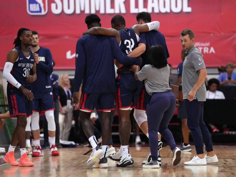New Orleans Pelicans forward E.J. Liddell is helped off the court after suffering a knee injury on Monday.