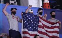 FILE - In this July 25, 2021, file photo, members of the United States artistic gymnastics men's team cheer for the women's team from the stands during the women's artistic gymnastic qualifications at the 2020 Summer Olympics, in Tokyo. In arenas across Tokyo, athletes accustomed to feeding off the deafening roar of the crowd are searching for new ways to feel Olympic enthusiasm. They’re rooting for each other as loudly as they can. (AP Photo/Gregory Bull, File)