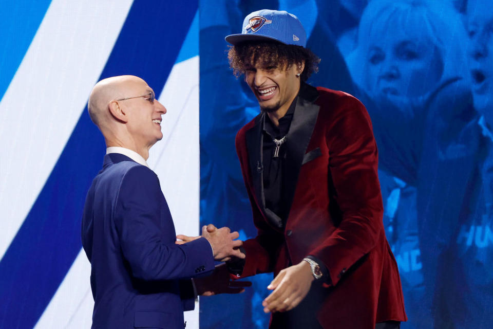 Dereck Lively II in an Indochino Hamilton Velvet Burgundy Tuxedo with NBA commissioner Adam Silver after being drafted 12th overall pick by the Oklahoma City Thunder during the first round of the 2023 NBA Draft.