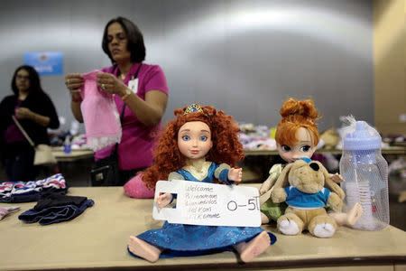 Volunteers sort donated clothes for Caribbean refugees whose homes were destroyed by Hurricane Irma, at a convention centre in San Juan, Puerto Rico September 14, 2017. REUTERS/Alvin Baez