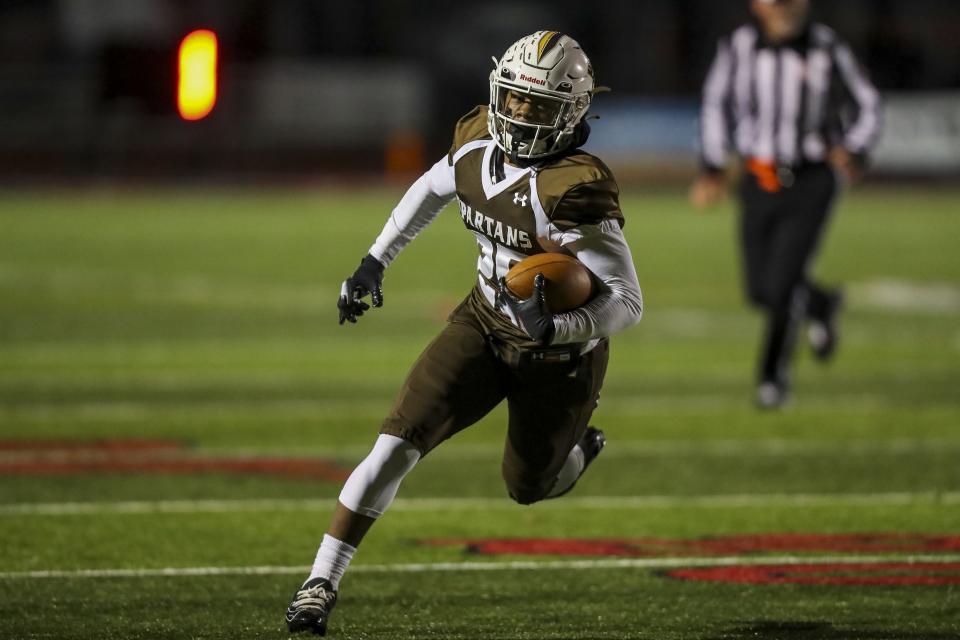 Roger Bacon running back Charles Hawkins (29) runs with the ball for a touchdown against Preble Shawnee in the first half at Lakota West High School, Nov. 13, 2021.