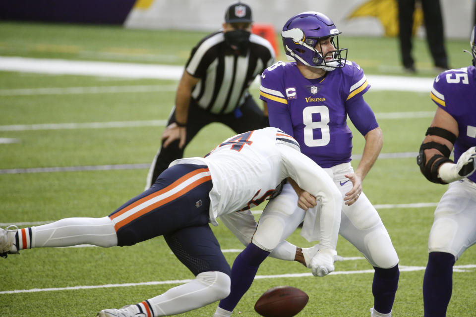 Minnesota Vikings quarterback Kirk Cousins (8) fumbles as he is hit by Chicago Bears linebacker Robert Quinn, left, during the first half of an NFL football game, Sunday, Dec. 20, 2020, in Minneapolis. (AP Photo/Bruce Kluckhohn)