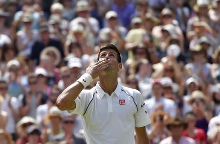 Novak Djokovic of Serbia celebrates after winning his match against Jarkko Nieminen of Finland at the Wimbledon Tennis Championships in London, July 1, 2015. REUTERS/Toby Melville