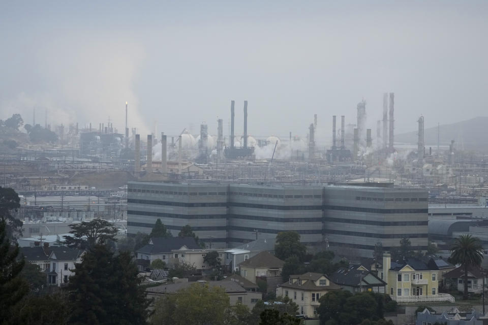 Seen is the Chevron Richmond Refinery in this view from Point Richmond, Calif., Tuesday, Oct. 24, 2023. Chevron is buying Hess Corp. for $53 billion and it's not even the biggest acquisition in the energy sector this month as major producers seize the initiative while oil prices surge. The Chevron-Hess deal comes less than two weeks after Exxon Mobil said that it would acquire Pioneer Natural Resources for about $60 billion. (AP Photo/Eric Risberg)