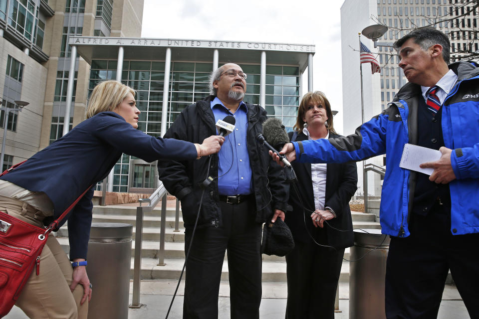 John Leon, center, the father of slain Denver computer technician and pizza deliveryman Nathan Leon, answers questions from members of the media following a sentencing hearing for a woman who pleaded guilty to buying the handgun used to kill Leon and the director of Colorado Prisons, at the Federal Courthouse, in Denver, Monday March 3, 2014. John Leon's wife Jaye Leon stands with him. Prosecutors had asked for six years for Stevie Marie Anne Vigil, for buying the handgun for Evan Ebel, a parolee and member of a white supremacist prison gang. But federal Judge Christine Arguello said prosecutors had failed to show Vigil knew of Ebel's plans. (AP Photo/Brennan Linsley)