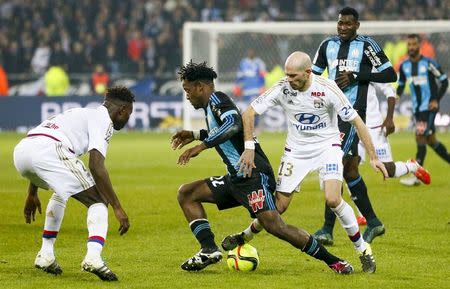 Football Soccer - Olympique Lyon v Olympique Marseille - French Ligue 1 - Grand Stade stadium, Decines, France - 24/1/2016 Olympique Lyon's Christophe Jallet (R) in action against Olympique Marseille's Michy Batshuayi (C) REUTERS/Robert Pratta