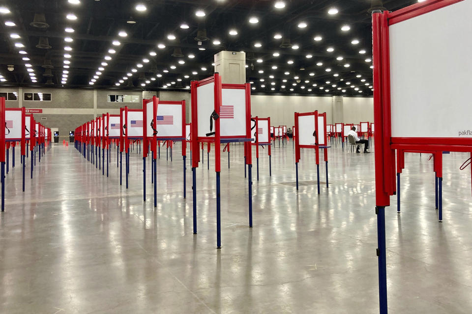 FILE - This June 22, 2020, file photo shows voting stations set up for the primary election at the Kentucky Exposition Center in Louisville, Ky. Voting will look a little different this November. States are considering drive-thrus, outdoor polling places and curbside voting as they examine creative ways to safely offer same-day polling places during a pandemic. (AP Photo/Piper Blackburn, File)