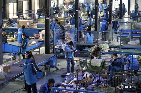 Employees work at a sorting centre of Zhongtong (ZTO) Express ahead of the Singles Day shopping festival, Chaoyang District, Beijing, November 8, 2015. REUTERS/Jason Lee