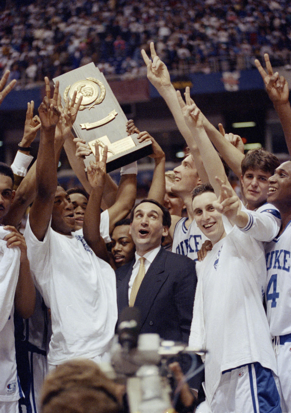 FILE - Duke coach Mike Krzyzewski and his team celebrate after defeating Michigan 71-51 in the NCAA college basketball Final Four championship game in Minneapolis, April 7, 1992. (AP Photo/Jim Mone, File)