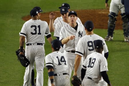 New York Yankees third baseman Todd Frazier (29) celebrates with his teammates after beating the Houston Astros in game five of the 2017 ALCS playoff baseball series at Yankee Stadium, Bronx, NY, USA, October 18, 2017. Mandatory Credit: Adam Hunger-USA TODAY Sports