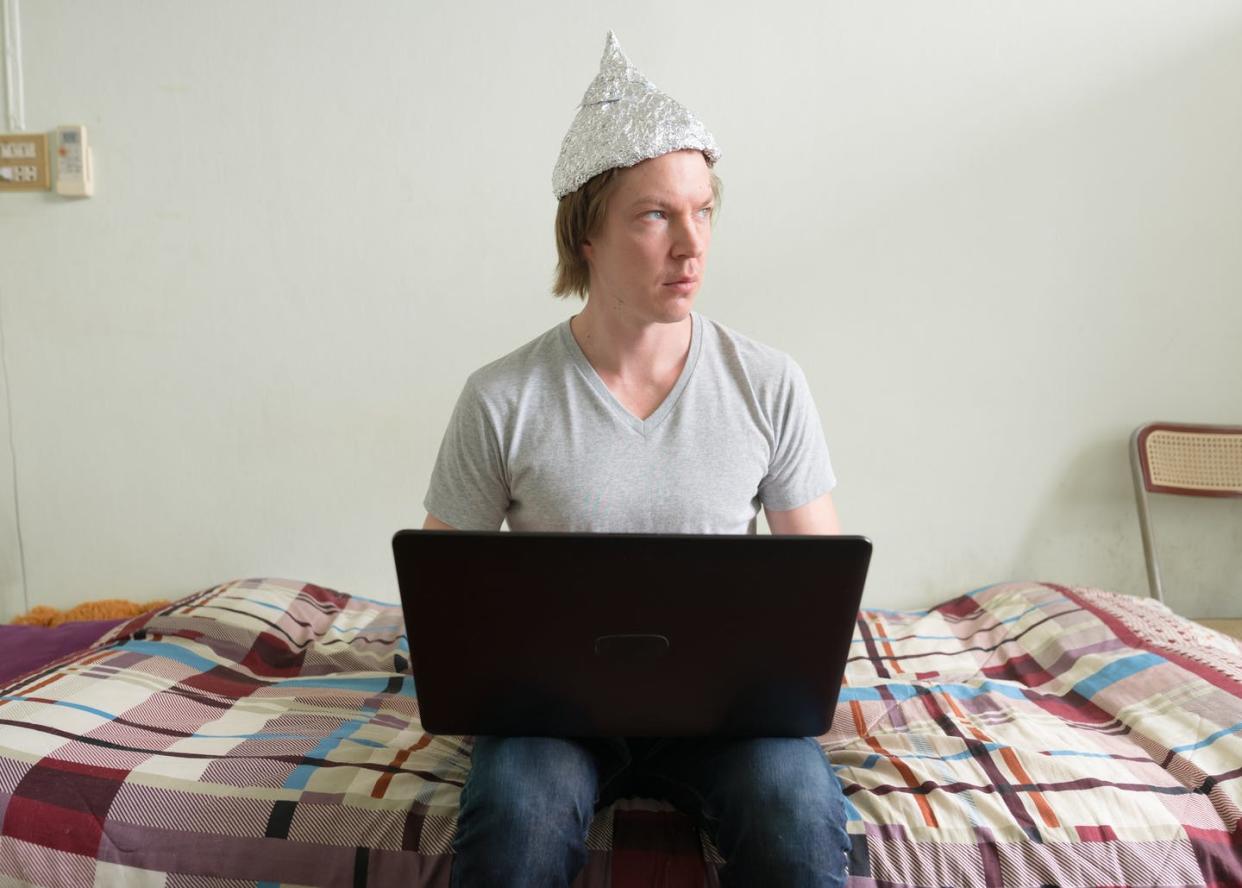 <span class="caption">No matter the details of the plot, conspiracy theories follow common patterns of thought.</span> <span class="attribution"><a class="link " href="https://www.gettyimages.com/detail/photo/young-man-with-tin-foil-hat-thinking-while-using-royalty-free-image/1209163064" rel="nofollow noopener" target="_blank" data-ylk="slk:Ranta Images/iStock/Getty Images Plus;elm:context_link;itc:0;sec:content-canvas">Ranta Images/iStock/Getty Images Plus</a></span>