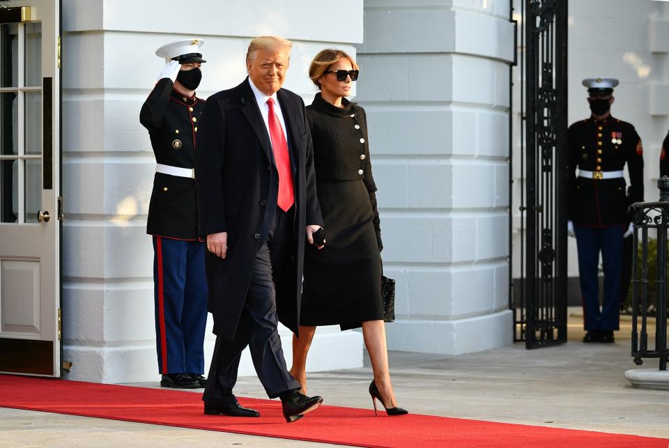 US President Donald Trump and First Lady Melania make their way to board Marine One before departing from the South Lawn of the White House in Washington, DC on January 20, 2021. - President Trump travels his Mar-a-Lago golf club residence in Palm Beach, Florida, and will not attend the inauguration for President-elect Joe Biden.