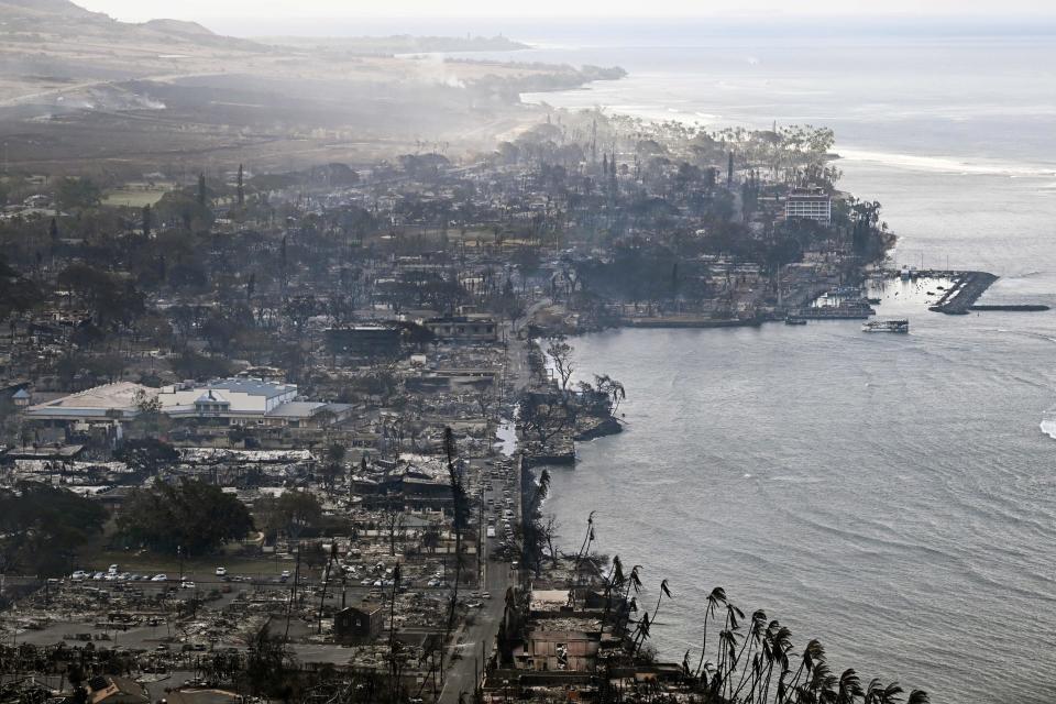 TOPSHOT - An aerial image taken on August 10, 2023 shows destroyed homes, buildings, and the harbor area burned to the ground in Lahaina in the aftermath of wildfires in western Maui, Hawaii. At least 36 people have died after a fast-moving wildfire turned Lahaina to ashes, officials said August 9, as visitors asked to leave the island of Maui found themselves stranded at the airport. The fires began burning early August 8, scorching thousands of acres and putting homes, businesses and 35,000 lives at risk on Maui, the Hawaii Emergency Management Agency said in a statement. (Photo by Patrick T. Fallon / AFP) (Photo by PATRICK T. FALLON/AFP via Getty Images)