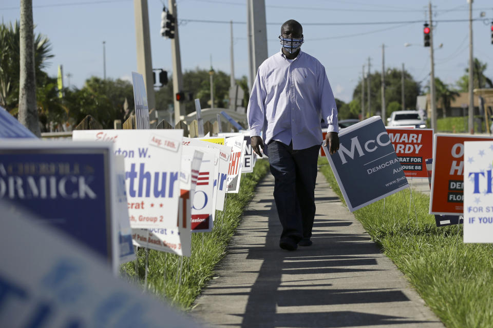 William Freeman, 51, walks outside of his polling station, Monday, Aug. 10, 2020, in Riviera Beach, Fla. Freeman recently registered to vote after serving three years for grand theft, his fourth prison stint. (AP Photo/Lynne Sladky)