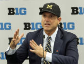 FILE - In this July 19, 2019, file photo, Michigan head coach Jim Harbaugh responds to a question during the Big Ten Conference NCAA college football media days in Chicago. Big Ten is going to give fall football a shot after all. Less than five weeks after pushing football and other fall sports to spring in the name of player safety during the pandemic, the conference changed course Wednesday, Sept. 16, 2020, and said it plans to begin its season the weekend of Oct. 23-24.(AP Photo/Charles Rex Arbogast, File)