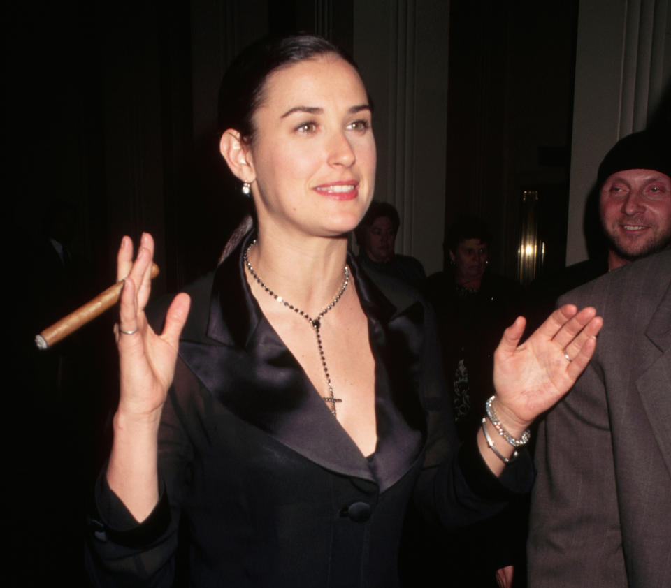 Demi Moore enjoys a cigar outside of Carnegie Hall in 1995