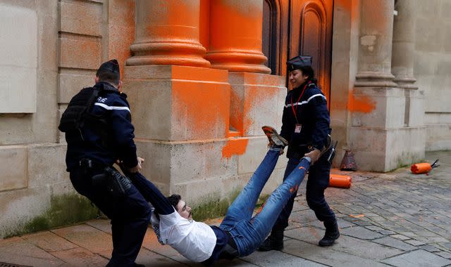 French climate activists spray-paint front of prime minister's office