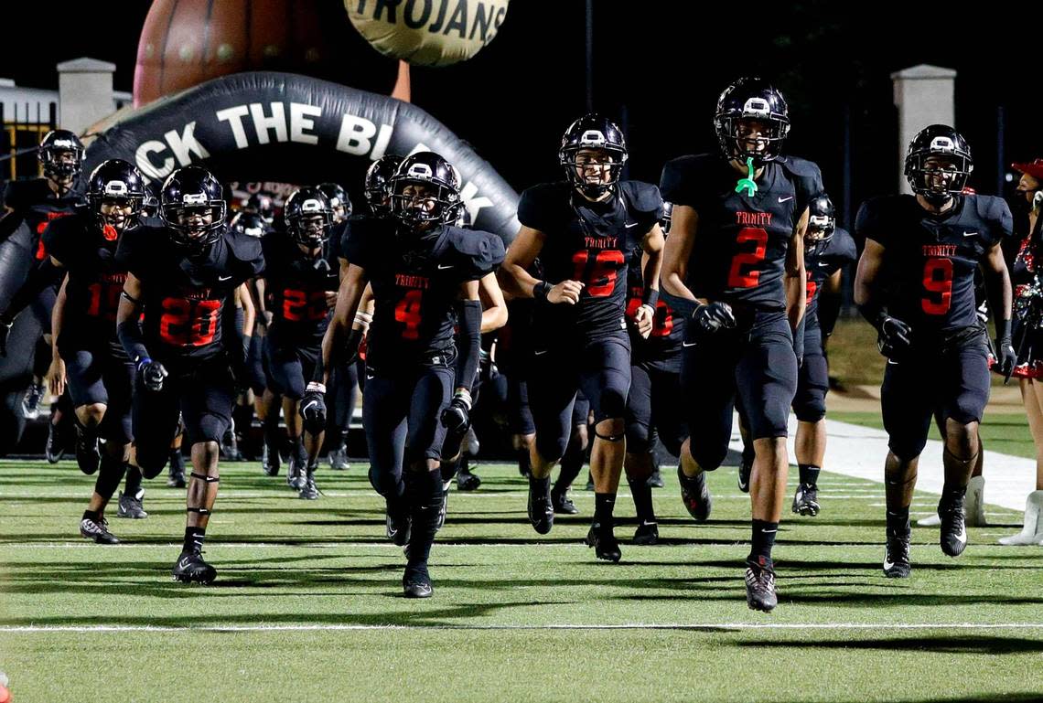 The Euless Trinity Trojans enter the field to face the North Crowley Panthers in a high school football game, Thursday night, November 5, 2020 played at Pennington Field in Bedford, Tx. (Steve Nurenberg Special to the Star-Telegram)