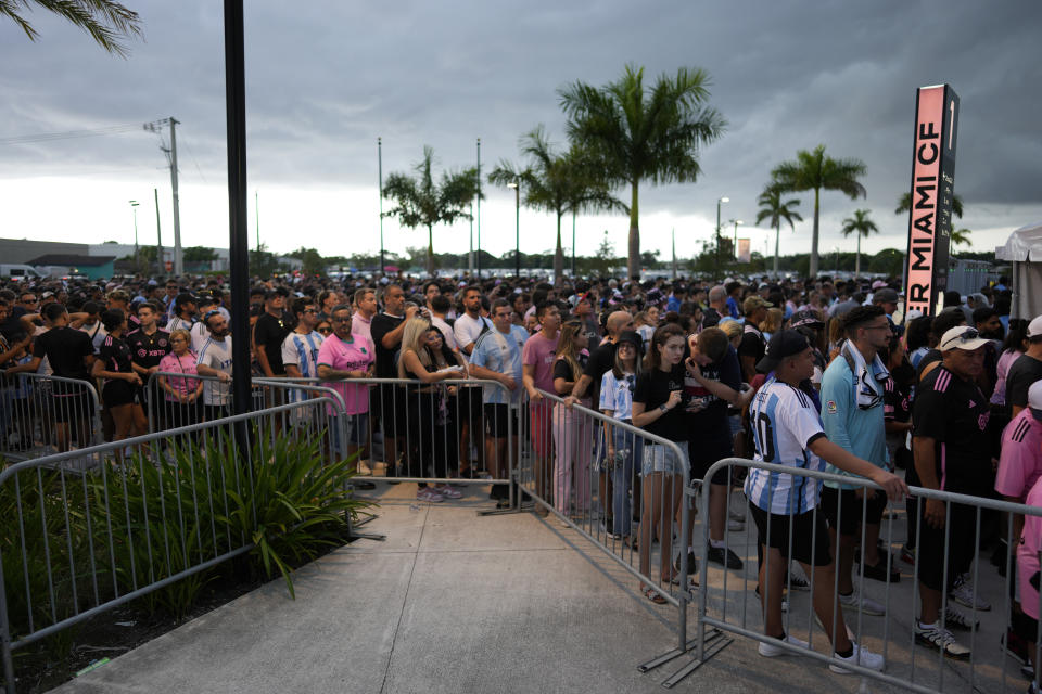 Fans wait to enter DRV Pink Stadium, home of the Inter Miami MLS soccer team, for an event to present international superstar Lionel Messi one day after the team finalized his signing through the 2025 season, Sunday, July 16, 2023, in Fort Lauderdale, Fla. (AP Photo/Rebecca Blackwell)
