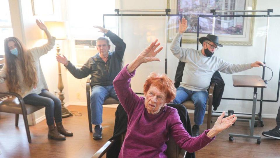 In front is Beverly Madeiros, back from left is Heather Bootzin a Cal Poly intern, Randy Zurback, Dan Walker and Ray Bayliss. They are doing stretching exercises via Zoom with Michelle Zulim-Clark a fall prevention program with San Luis Obispo County Health Department. CAPSLO Adult Day Center in Paso Robles provides adult day care for seniors with Alzheimer’s and other forms of dementia and respite for their family caregivers Jan. 13, 2022.