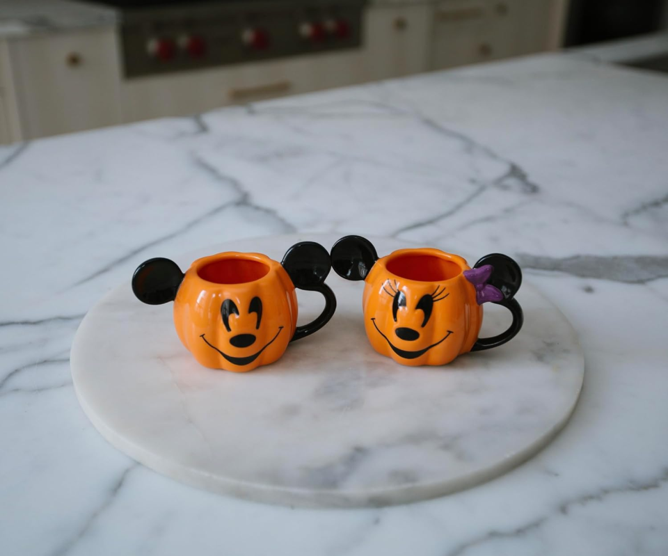 <p><a href="https://www.amazon.com/Disney-Decorations-Espresso-Housewarming-Official/dp/B0CFYR59RX/ref=sr_1_2_sspa?tag=syn-yahoo-20&ascsubtag=%5Bartid%7C10070.g.61170509%5Bsrc%7Cyahoo-us" rel="nofollow noopener" target="_blank" data-ylk="slk:Shop Now;elm:context_link;itc:0;sec:content-canvas" class="link ">Shop Now</a></p><p>Mickey and Minnie Pumpkin Mugs</p><p>Amazon</p><p>$19.98</p>