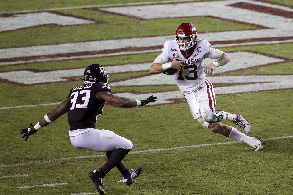 COLLEGE STATION, TEXAS – OCTOBER 31: Feleipe Franks #13 of the Arkansas Razorbacks runs the ball against Aaron Hansford #33 of the Texas A&M Aggies in the third quarter at Kyle Field on October 31, 2020 in College Station, Texas. (Photo by Tim Warner/Getty Images)