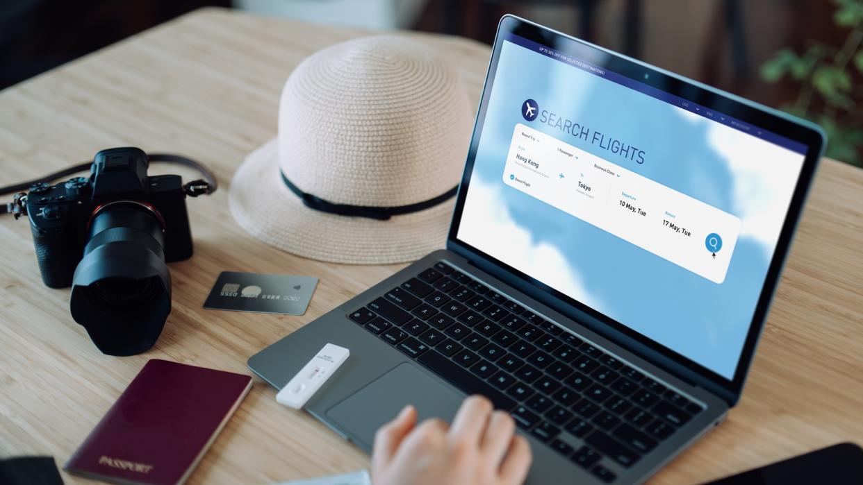  Person searching for flights on a computer. 