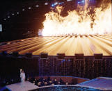 Torch Bearer Cathy Freeman made a dramatic entrance for the Sydney 2000 Olympic Games Opening Ceremony. The sprinter lit a ring of fire in a pool and waited for a saucer-like contraption to rise above her. But it didn't. For four agonizing minutes, she smiled and waited. A computer glitch was finally fixed and the flame flew up to meet the cauldron. (Ben Elters\Getty Images)