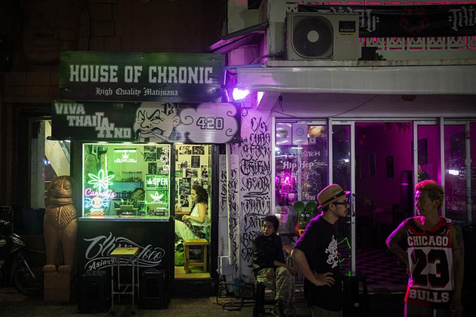 Customers gather outside House of Chronic, a marijuana dispensary in Bangkok.